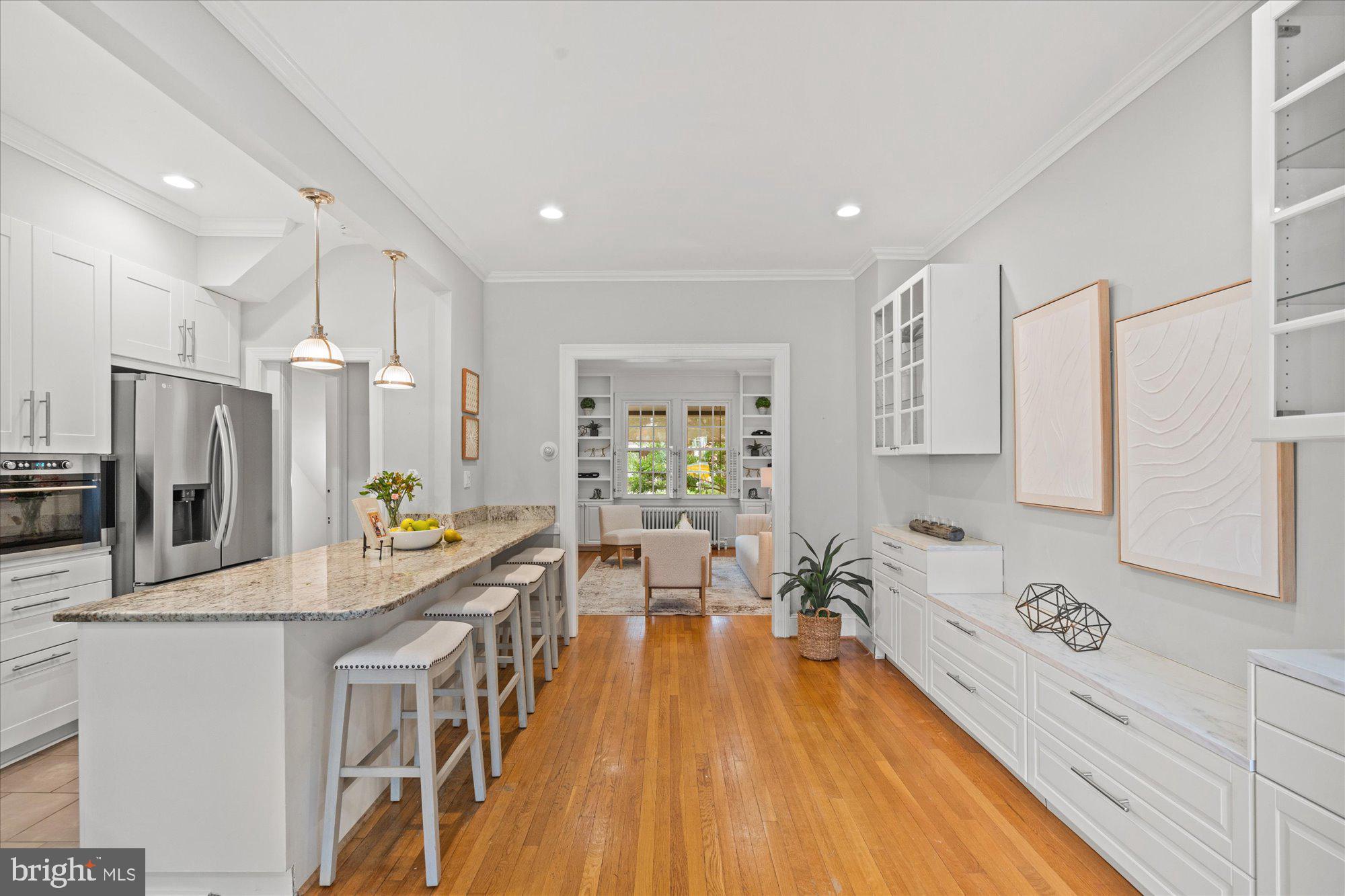 2305 38th Street Northwest Washington, DC 20007 - Photo 13 of 38 a view of a kitchen with kitchen island a counter top space a sink stainless steel appliances and cabinets