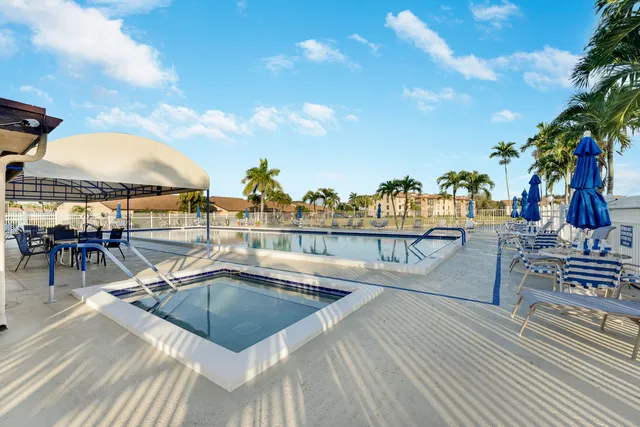 a view of a swimming pool with outdoor seating