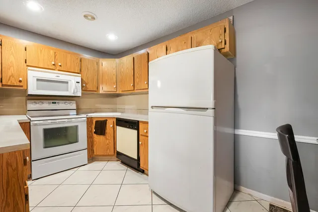 a kitchen with appliances cabinets and a sink