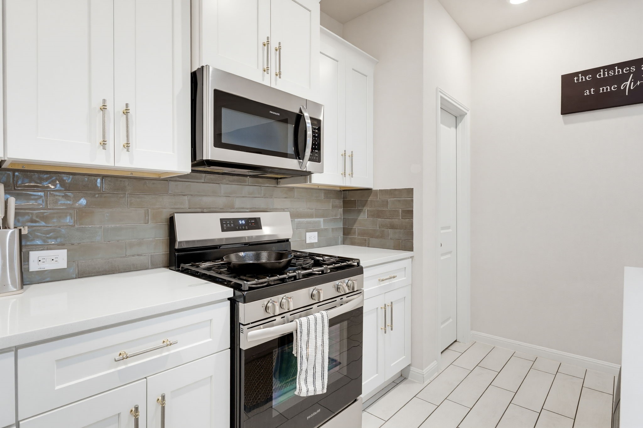 316 Windstar Road Liberty Hill, TX 78642 - Photo 8 of 27 a kitchen with stainless steel appliances granite countertop white cabinets a stove top oven