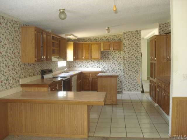 1001 Barnes Road Middlesex, NC 27557 - Photo 3 of 12 a kitchen with stainless steel appliances granite countertop a sink and a refrigerator