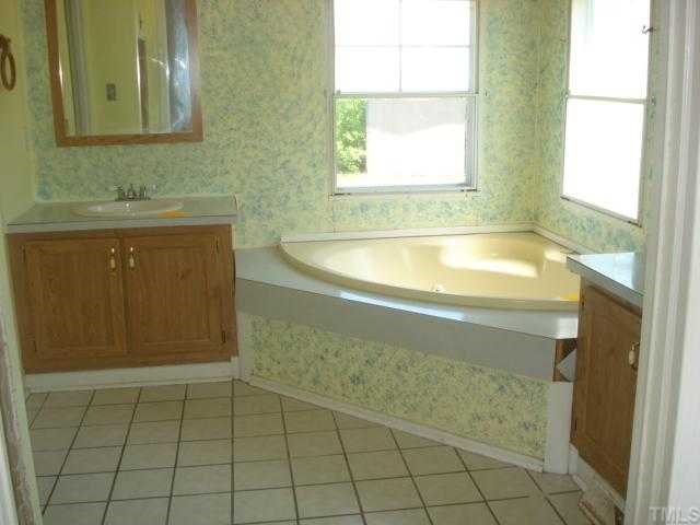 1001 Barnes Road Middlesex, NC 27557 - Photo 7 of 12 a bathroom with a bathtub and a sink