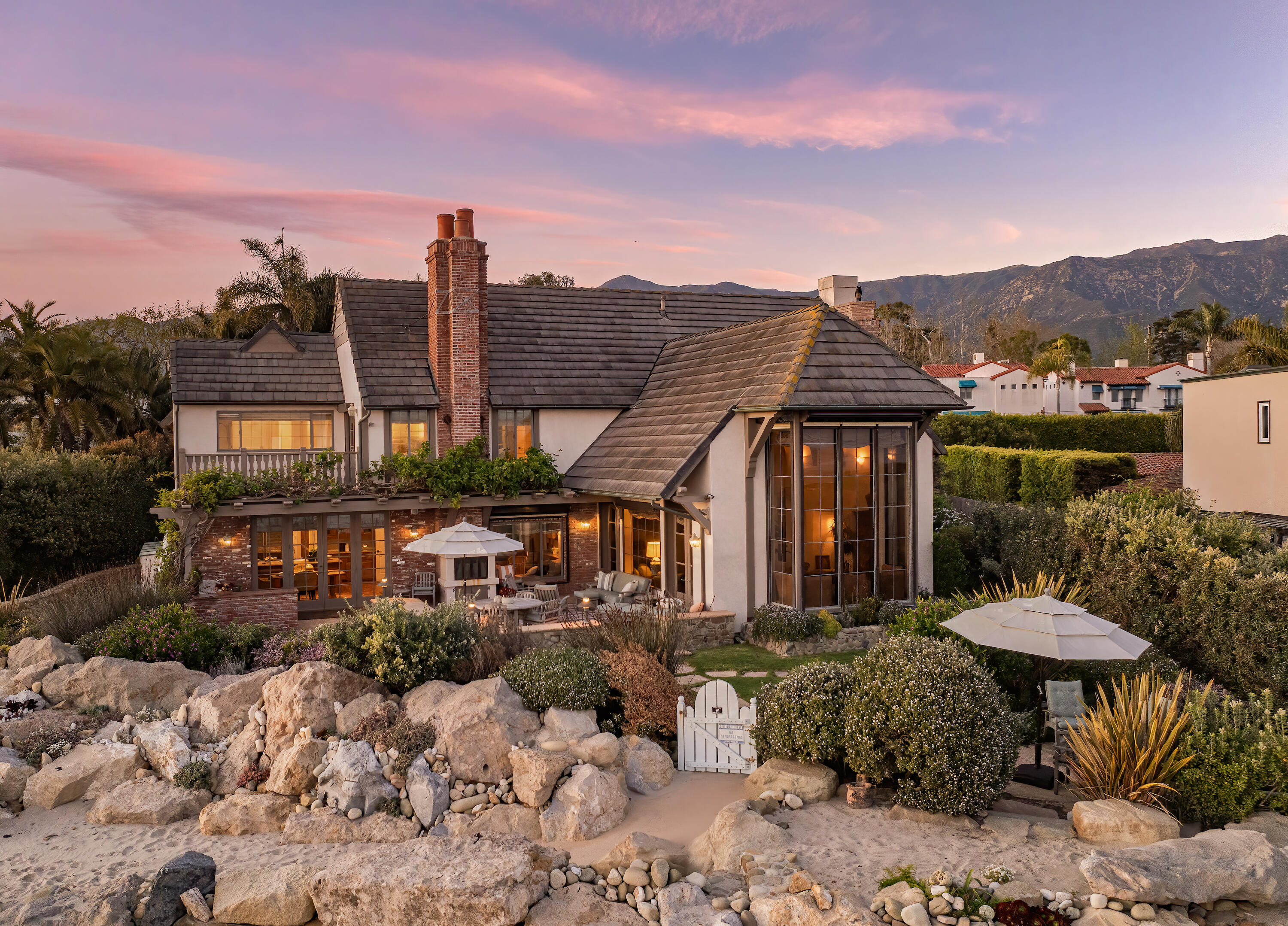 a view of a patio with a table and chairs under an umbrella