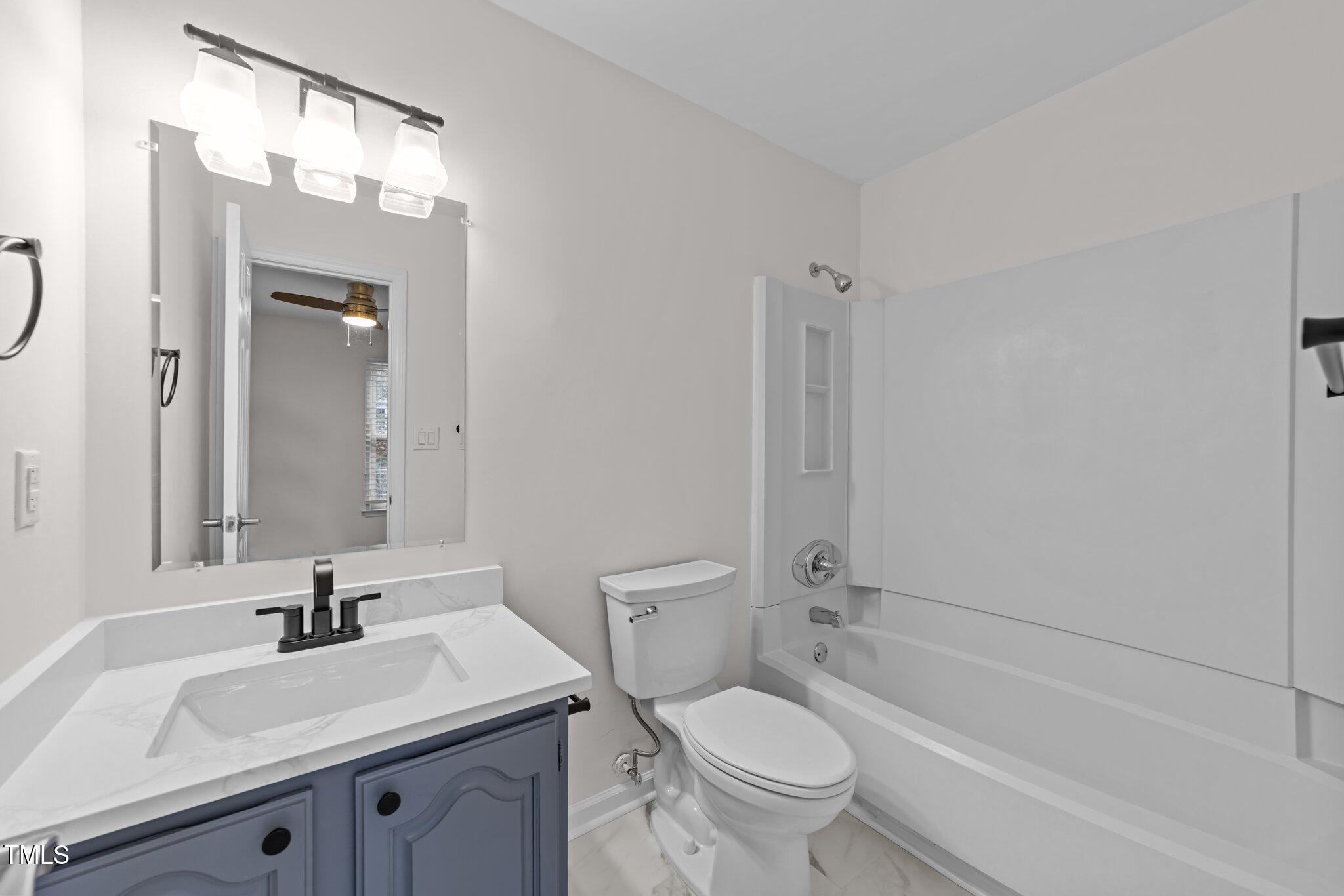 4541 Hershey Court Raleigh, NC 27613 - Photo 12 of 25 a bathroom with a granite countertop sink toilet and shower