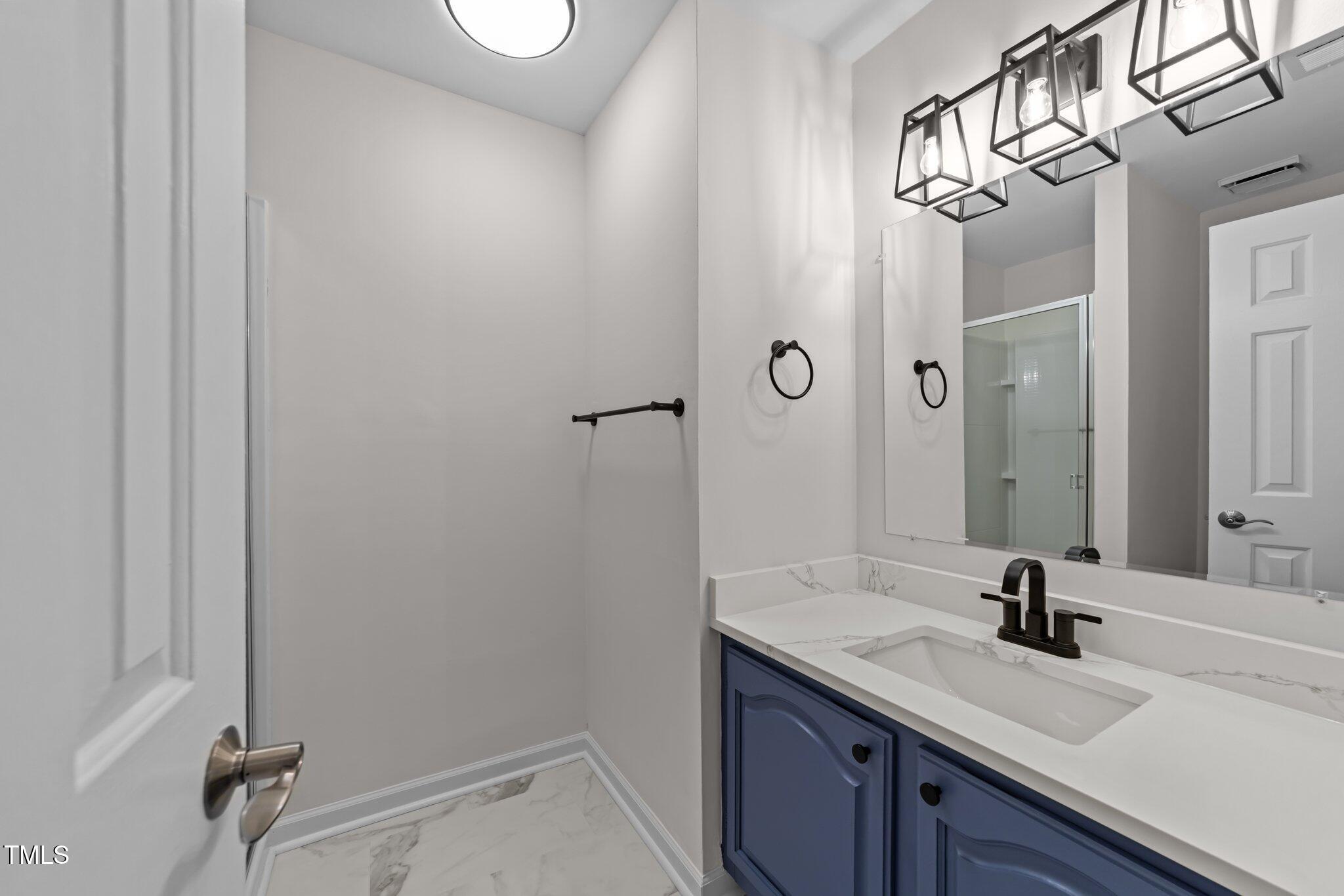 4541 Hershey Court Raleigh, NC 27613 - Photo 17 of 25 a bathroom with a sink and mirror