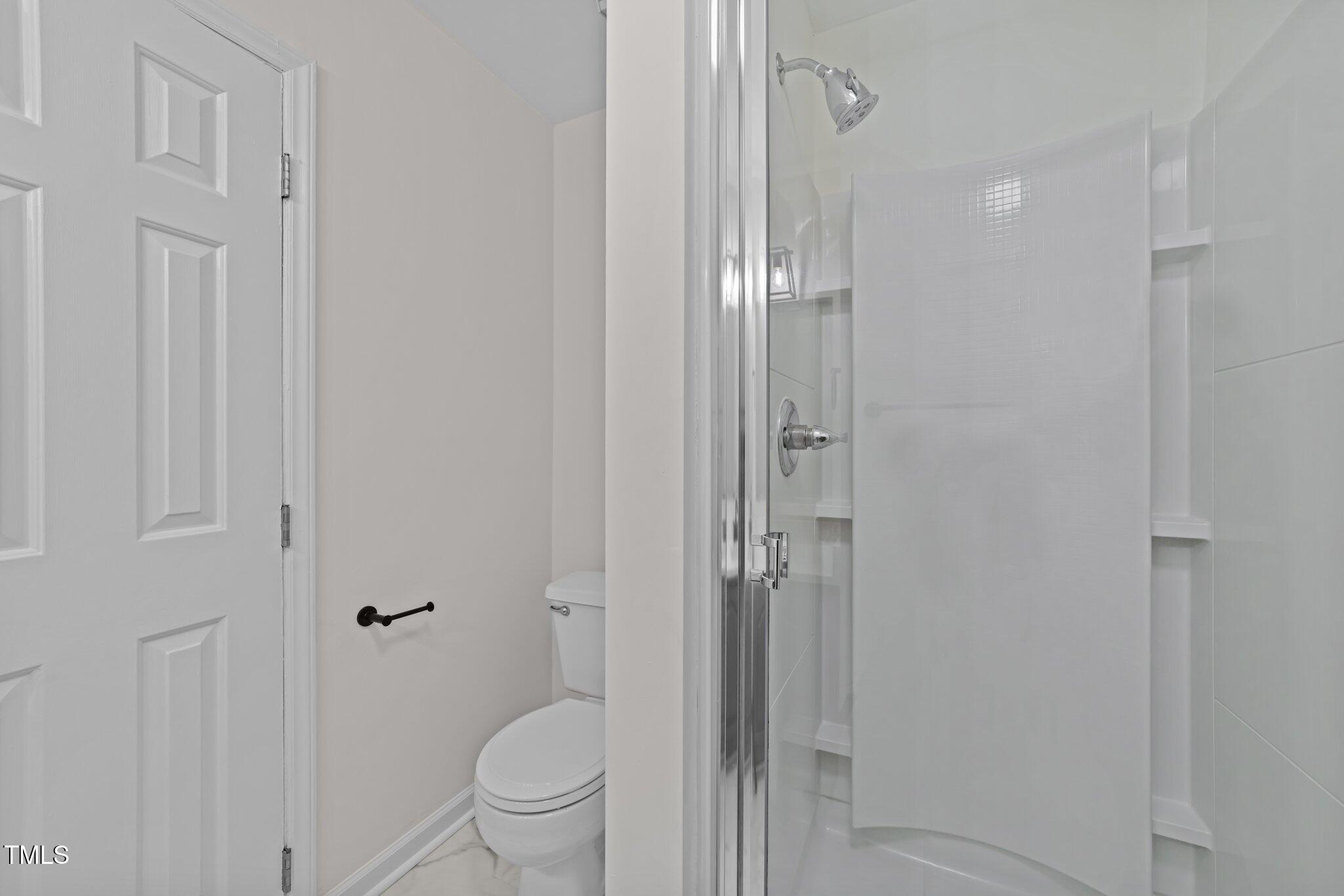 4541 Hershey Court Raleigh, NC 27613 - Photo 20 of 25 a bathroom with a shower and a toilet