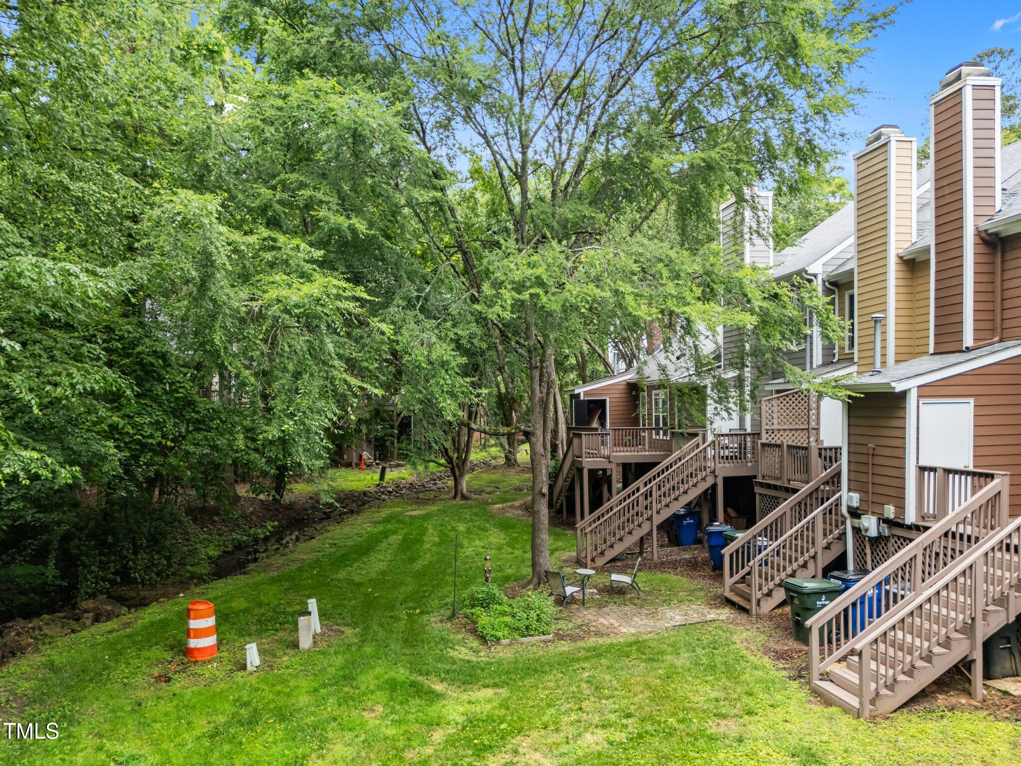 4541 Hershey Court Raleigh, NC 27613 - Photo 23 of 25 a view of backyard with a barn and a large tree