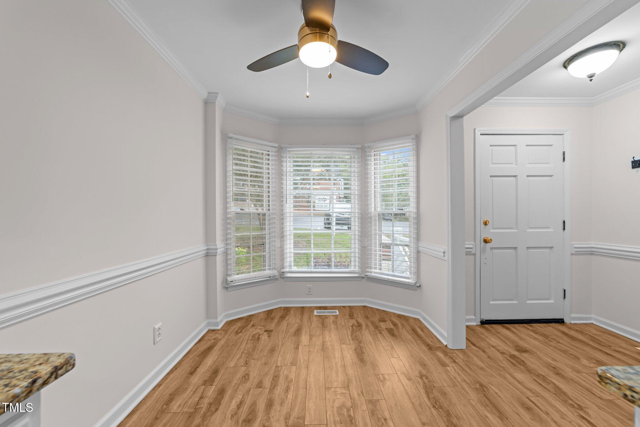 4541 Hershey Court Raleigh, NC 27613 - Photo 3 of 25 a view of empty room with wooden floor and fan