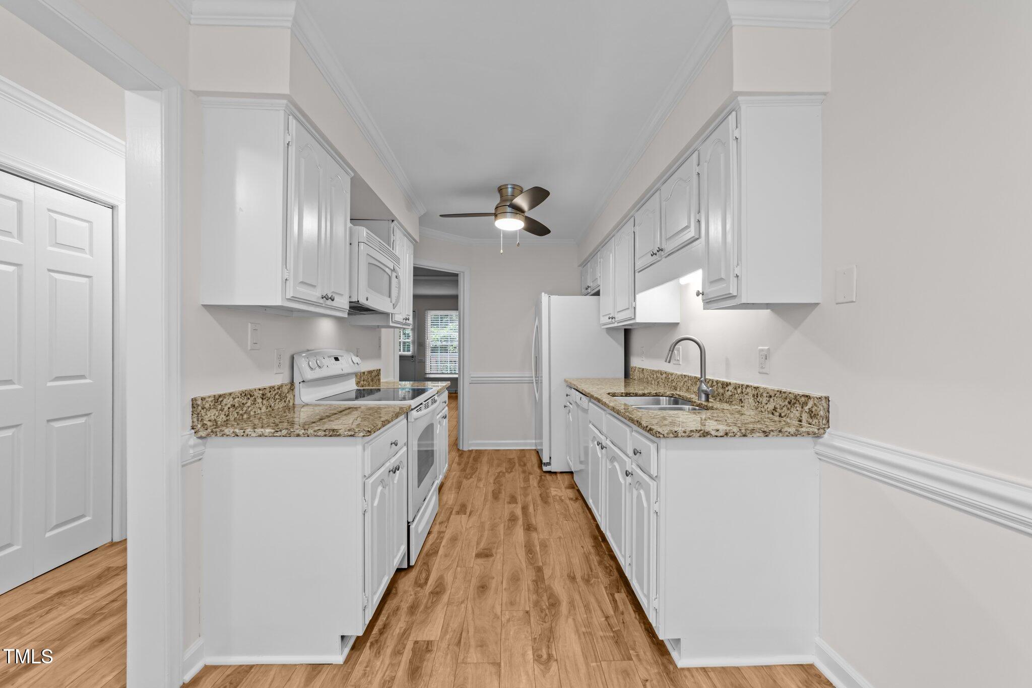 4541 Hershey Court Raleigh, NC 27613 - Photo 5 of 25 a kitchen with stainless steel appliances granite countertop a stove and a sink