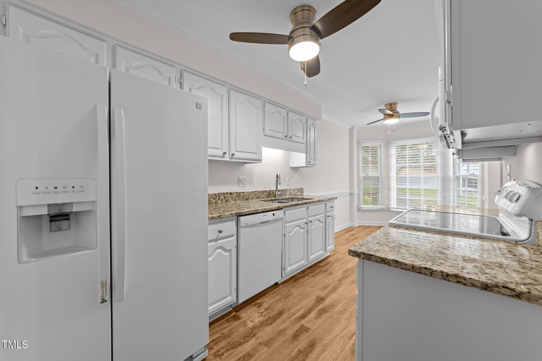 4541 Hershey Court Raleigh, NC 27613 - Photo 6 of 25 a kitchen with granite countertop a sink stainless steel appliances and cabinets