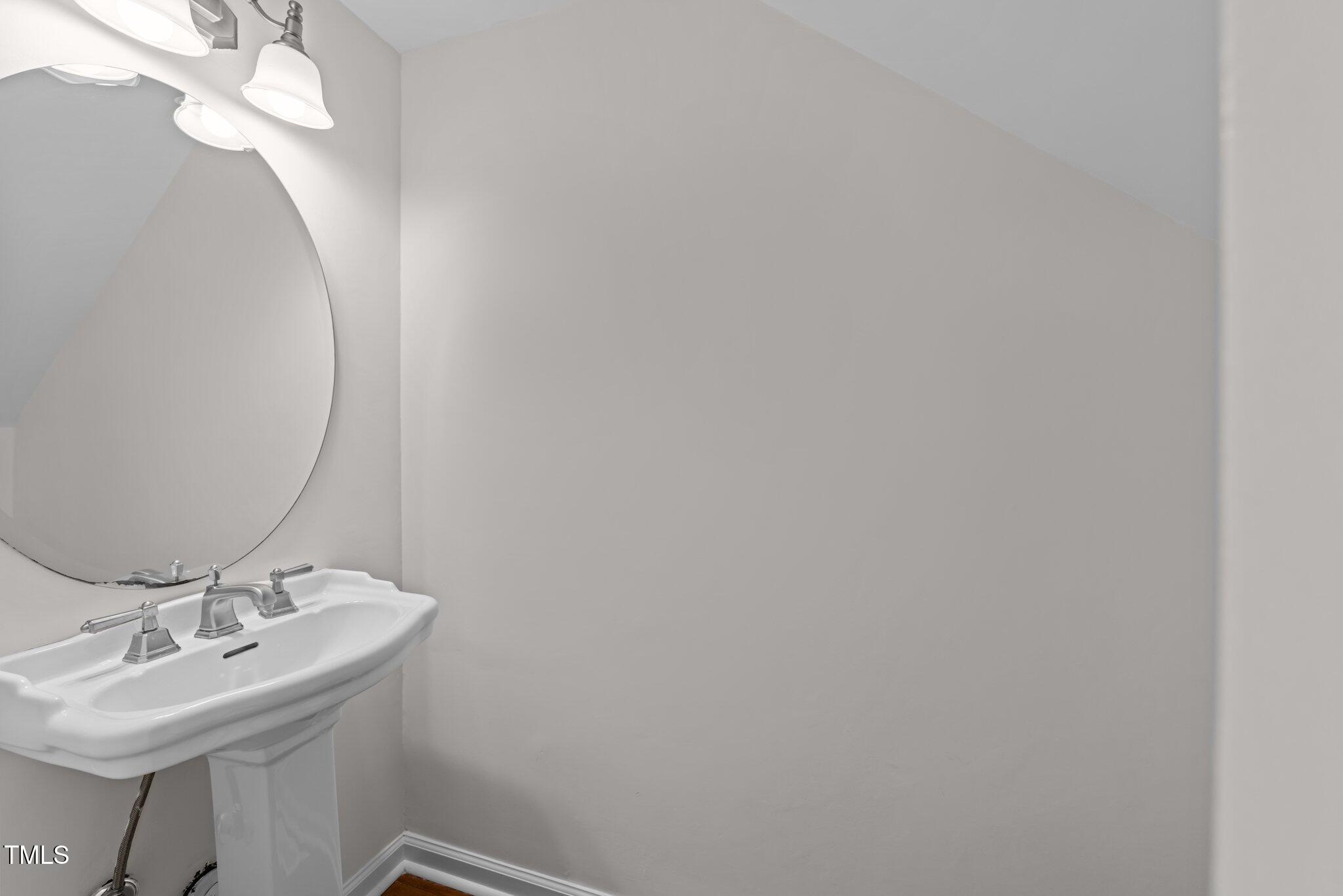 4541 Hershey Court Raleigh, NC 27613 - Photo 7 of 25 a bathroom with a sink and a mirror