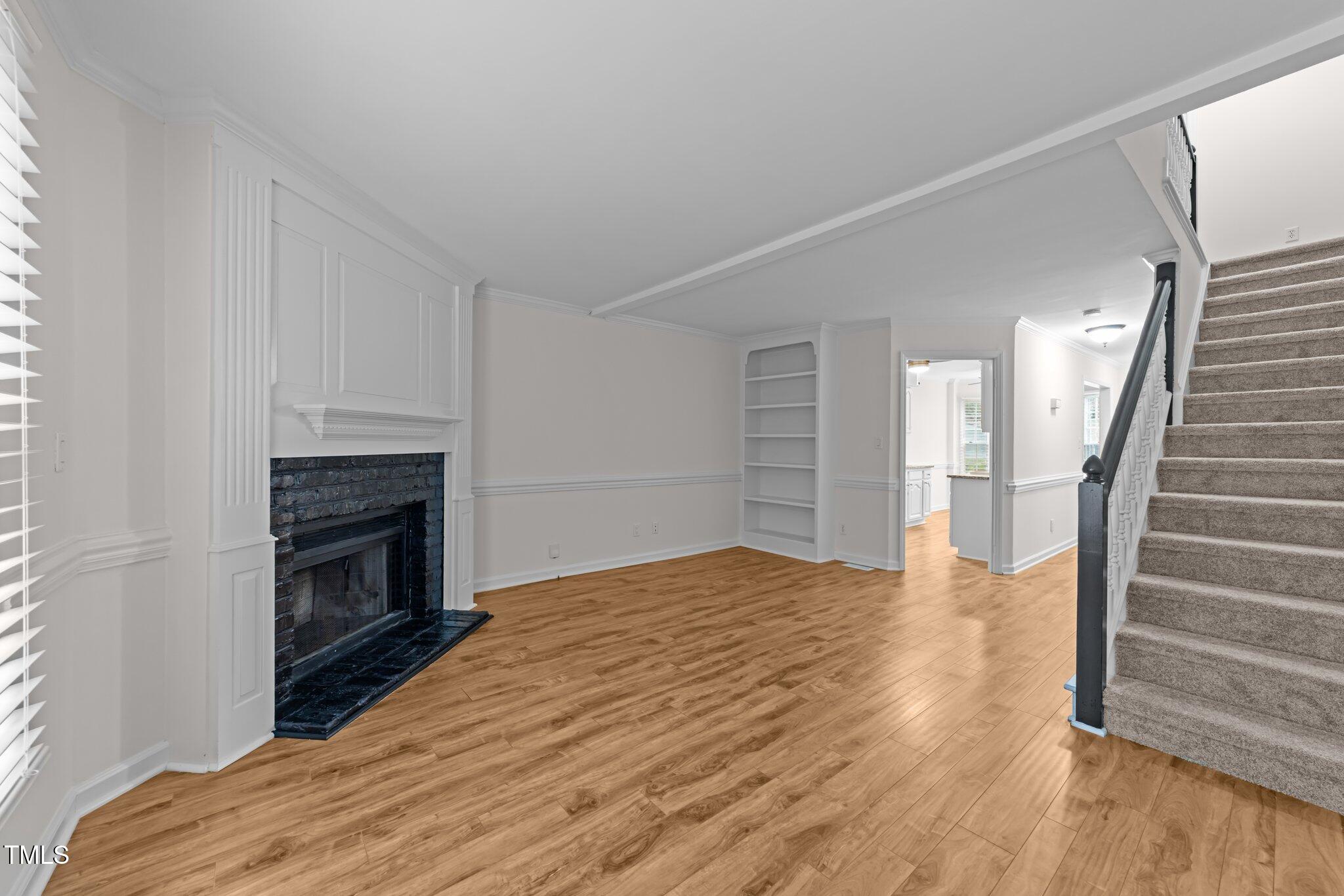 4541 Hershey Court Raleigh, NC 27613 - Photo 9 of 25 a view of a livingroom with wooden floor and a fireplace