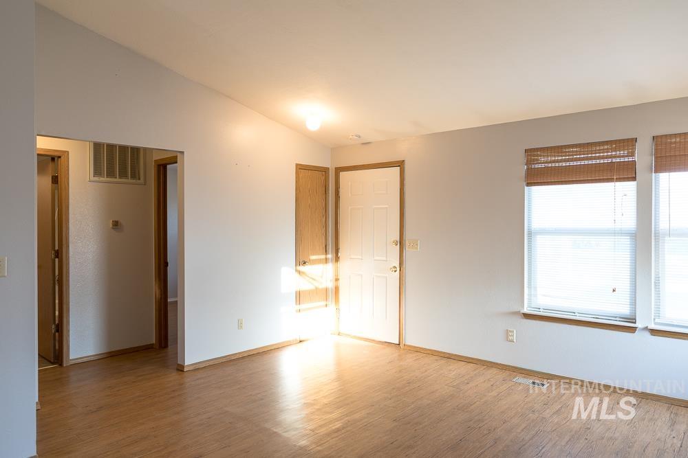 1158 Southwest 14th Avenue Ontario, OR 97914 - Photo 12 of 32 Unfurnished room featuring vaulted ceiling and light wood-style floors