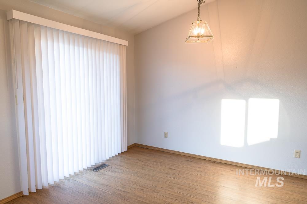 1158 Southwest 14th Avenue Ontario, OR 97914 - Photo 19 of 32 Empty room featuring wood finished floors and baseboards