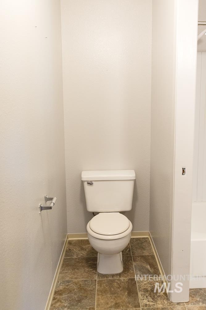 1158 Southwest 14th Avenue Ontario, OR 97914 - Photo 24 of 32 Bathroom featuring toilet and dark stone finish flooring