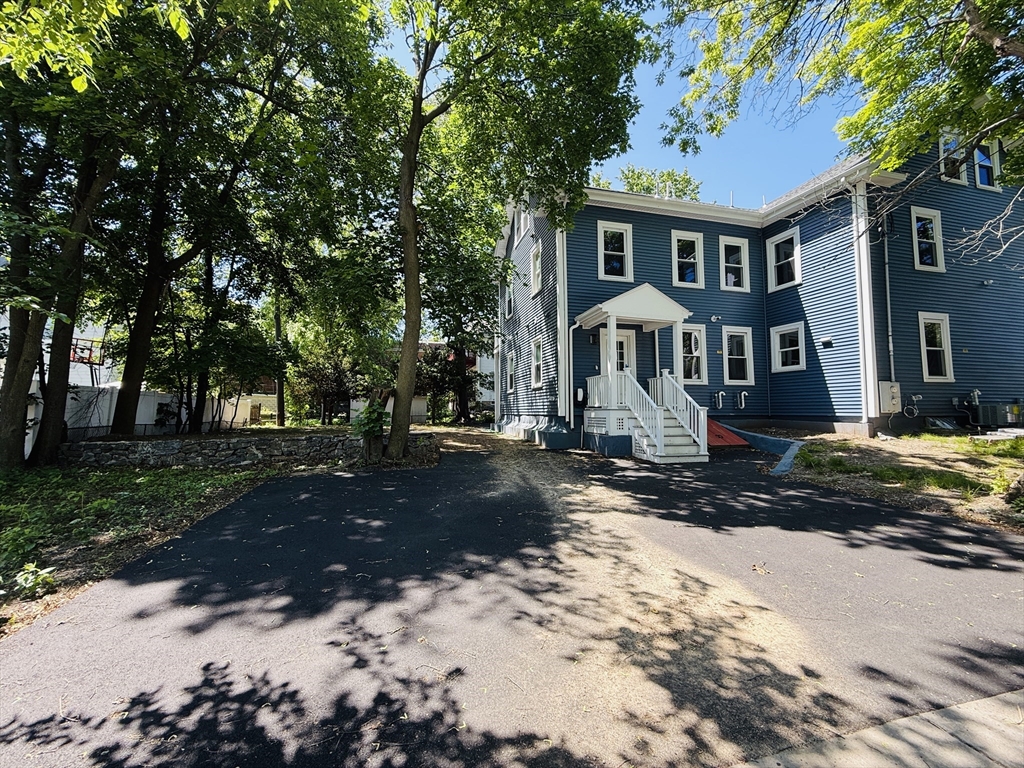 4 Baldwin Street, Unit 4 Newton, MA 02458 - Photo 26 of 30 a front view of a house with a yard