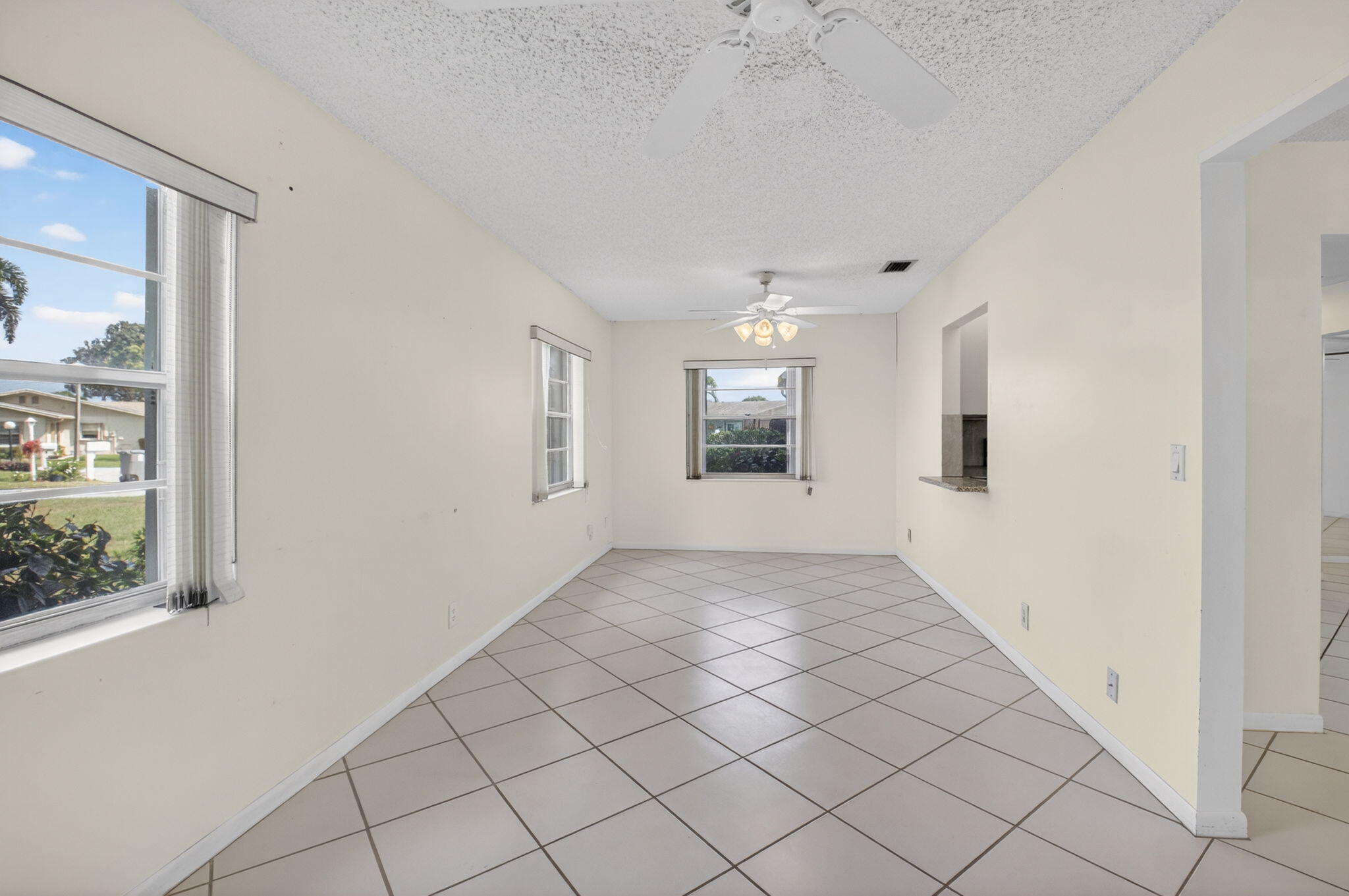 6321 Lasalle Road Delray Beach, FL 33484 - Photo 12 of 38 an empty room with windows and chandelier