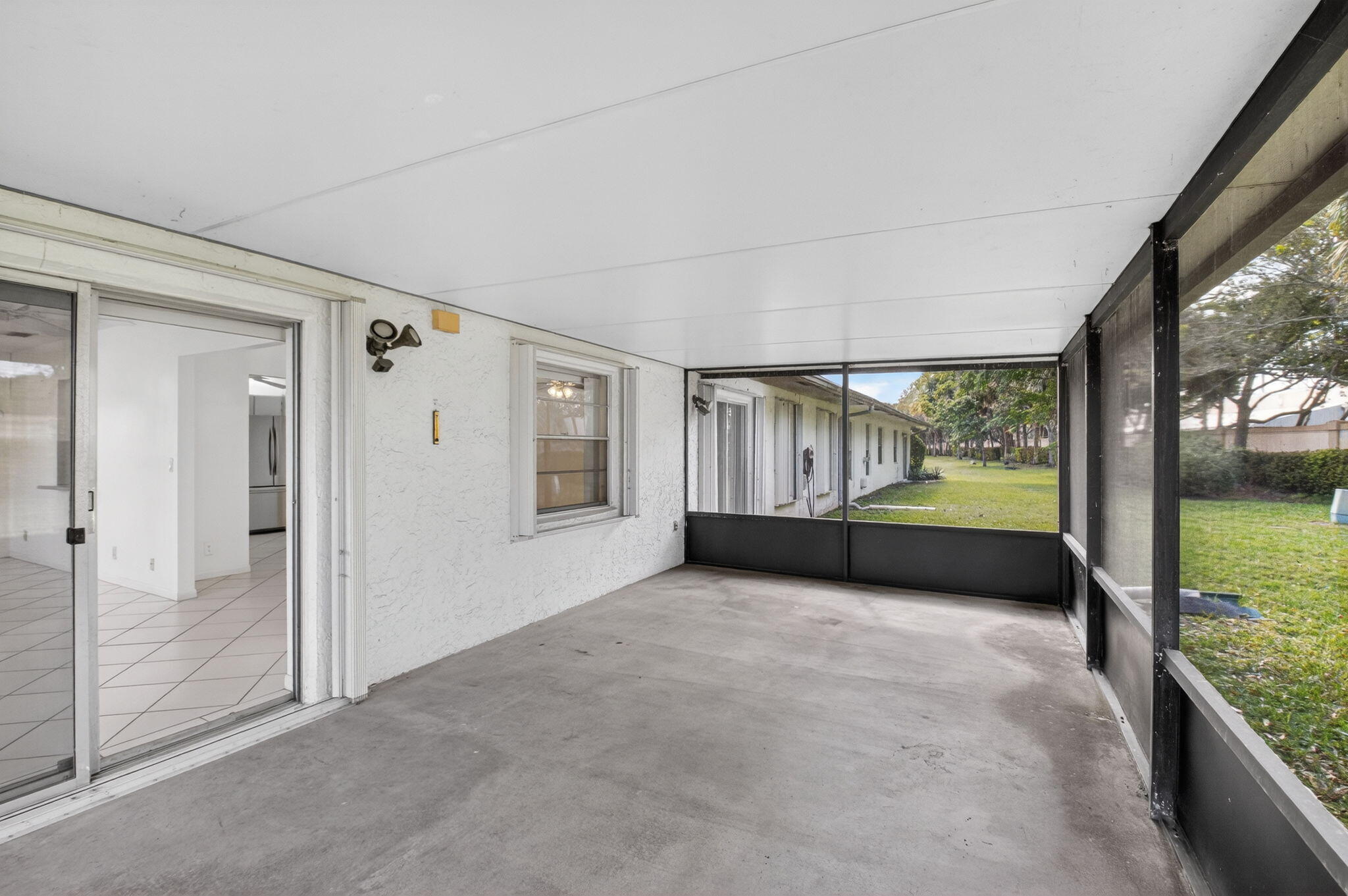 6321 Lasalle Road Delray Beach, FL 33484 - Photo 16 of 38 a view of an empty room with floor to ceiling windows and a room