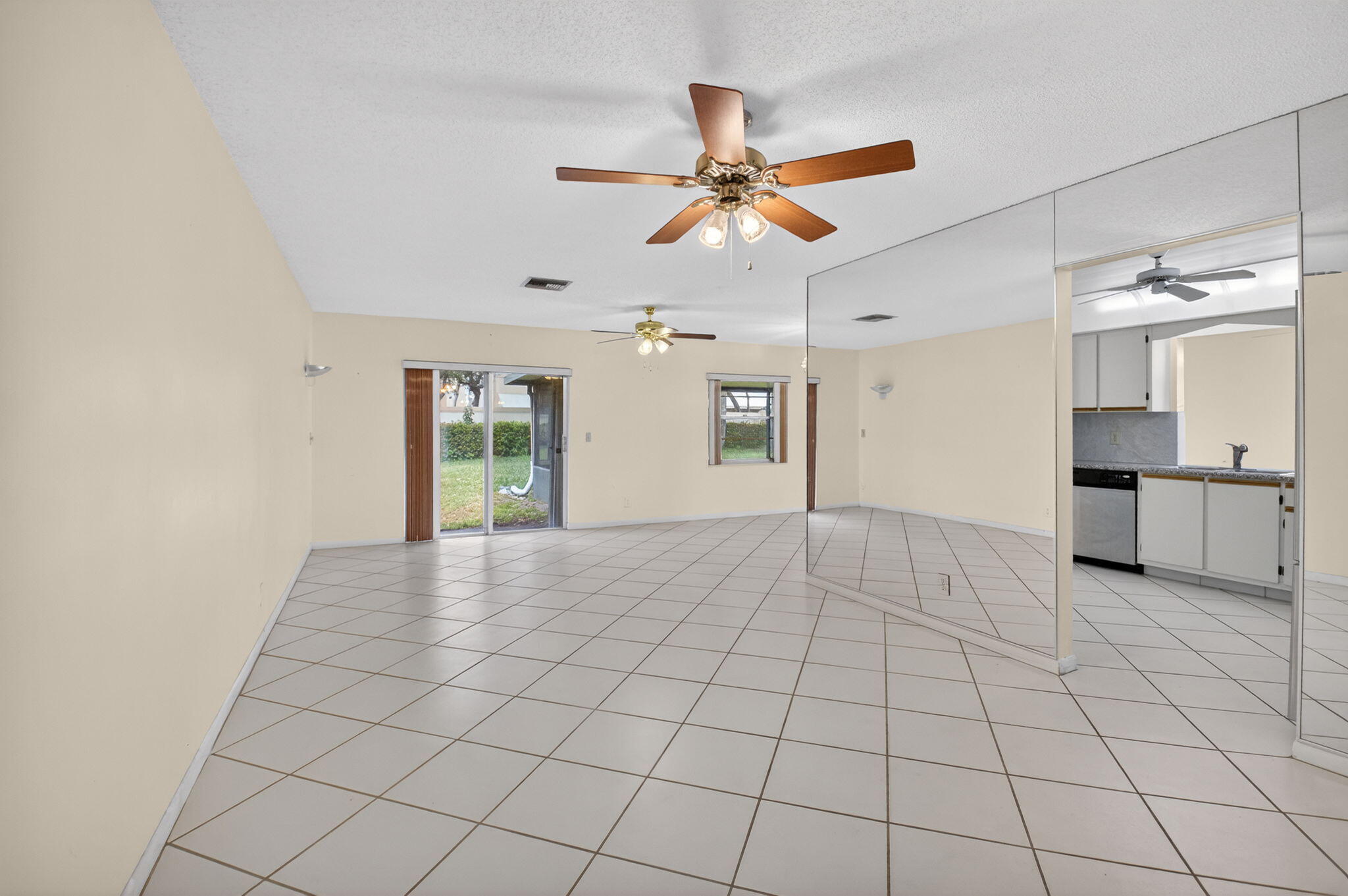 6321 Lasalle Road Delray Beach, FL 33484 - Photo 4 of 38 a view of an empty room and window and a kitchen