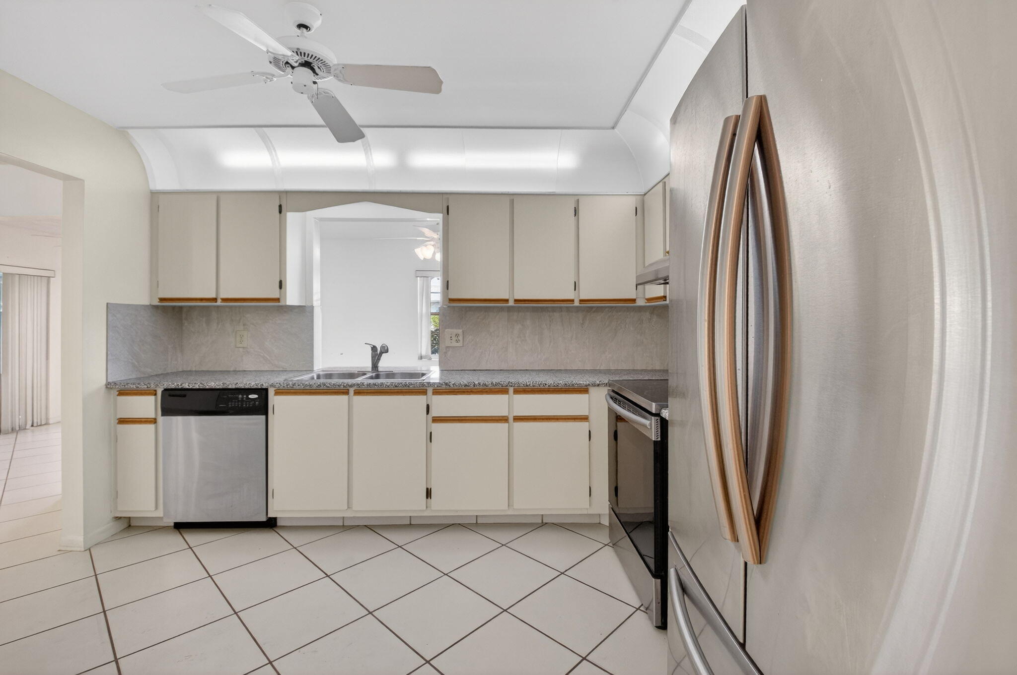 6321 Lasalle Road Delray Beach, FL 33484 - Photo 10 of 38 a kitchen with stainless steel appliances granite countertop a refrigerator and white cabinets