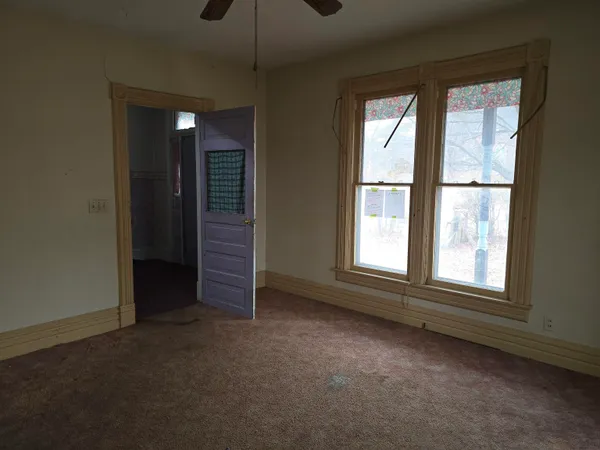 a view of staircase with wooden floor and front door