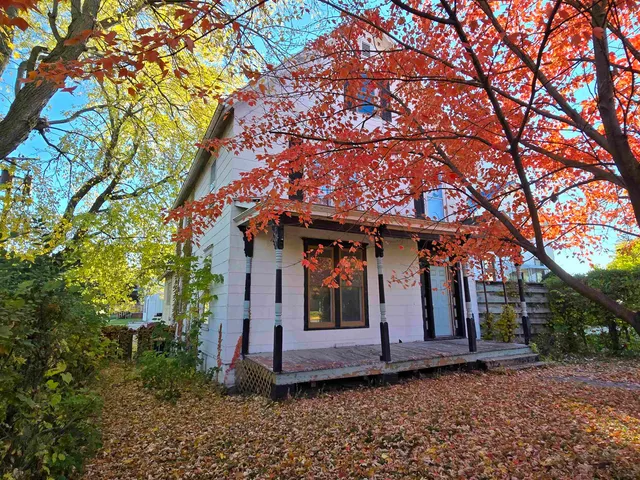 a view of a house with large trees