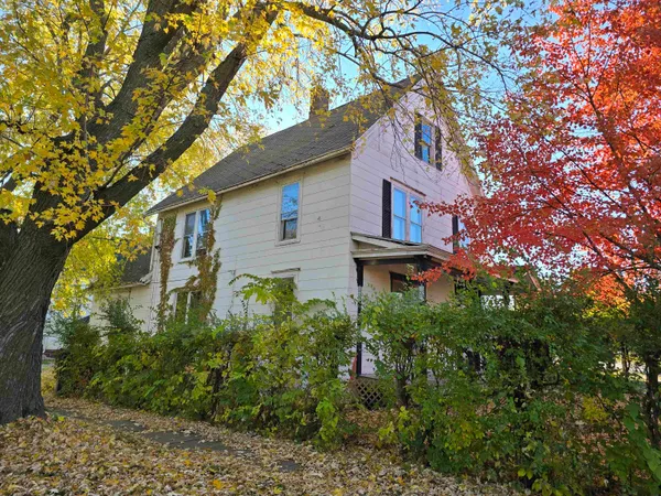 a house that has a tree in front of it