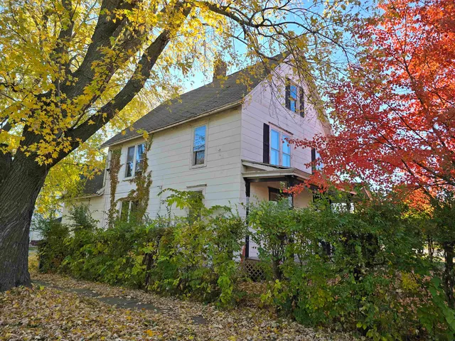 a house that has a tree in front of it