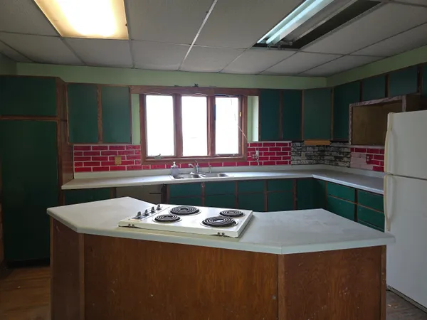 a kitchen with a sink and a refrigerator