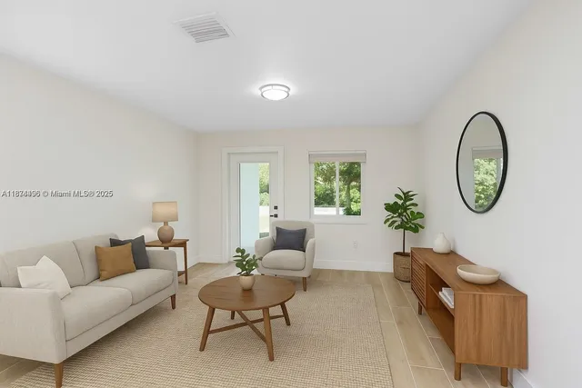 a living room with furniture and a mirror