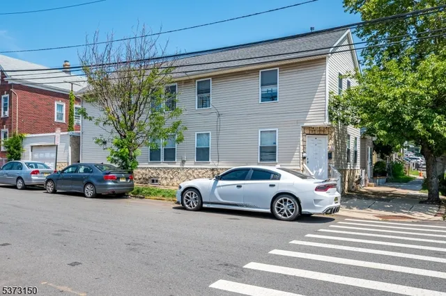 a view of a cars parked in front of a house
