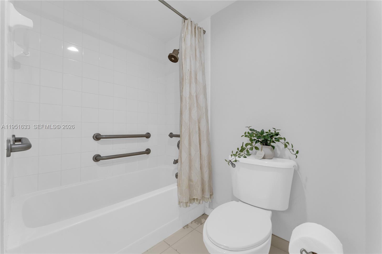 2400 East Preserve Way, Unit 101 Miramar, FL 33025 - Photo 15 of 41 a white toilet sitting next to a bath tub