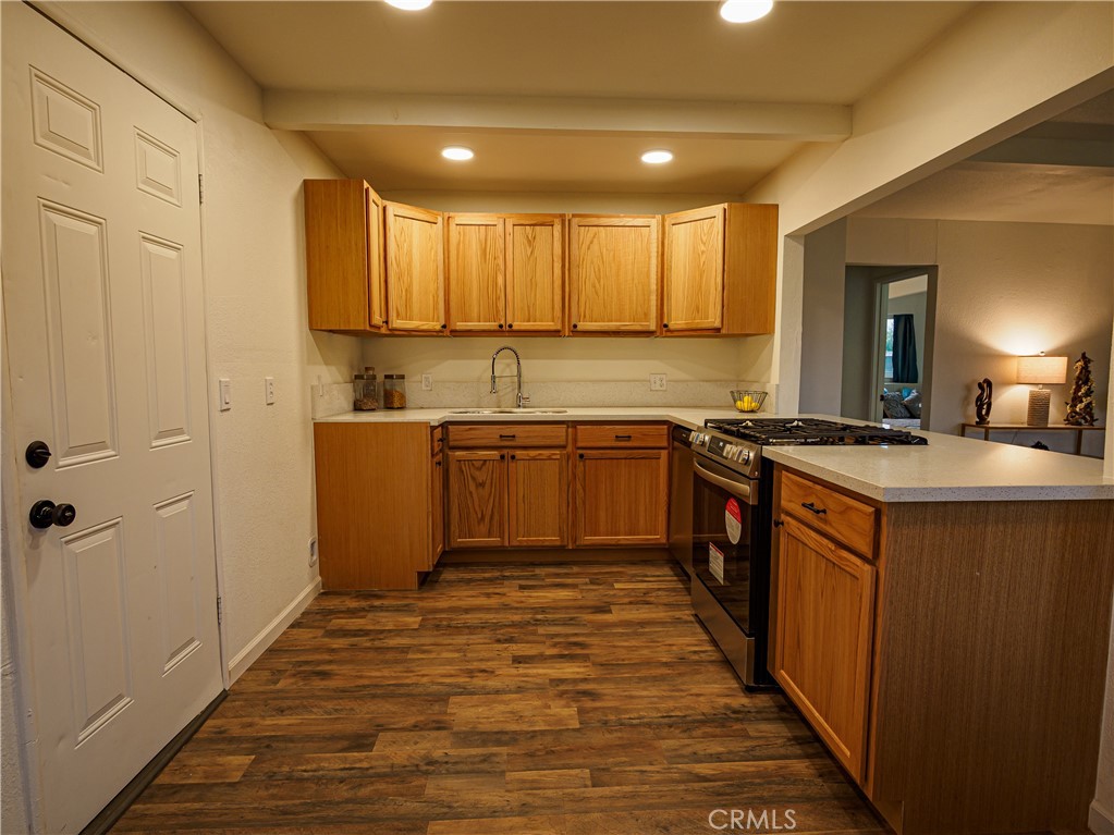 1745 Dale Avenue Merced, CA 95340 - Photo 5 of 18 a kitchen with stainless steel appliances granite countertop a stove a sink dishwasher and a refrigerator