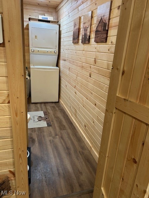 2445 McCord Hill Road Wellsburg, WV 26070 - Photo 12 of 37 Hallway with wooden walls, dark wood-style flooring, and stacked washing machine and dryer