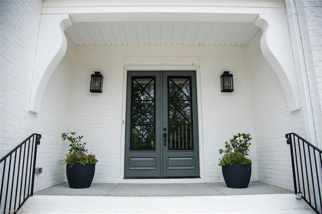 6900 Matzinger Court Oak Ridge, NC 27310 - Photo 2 of 30 Shavano mahogany front door with iron accents.