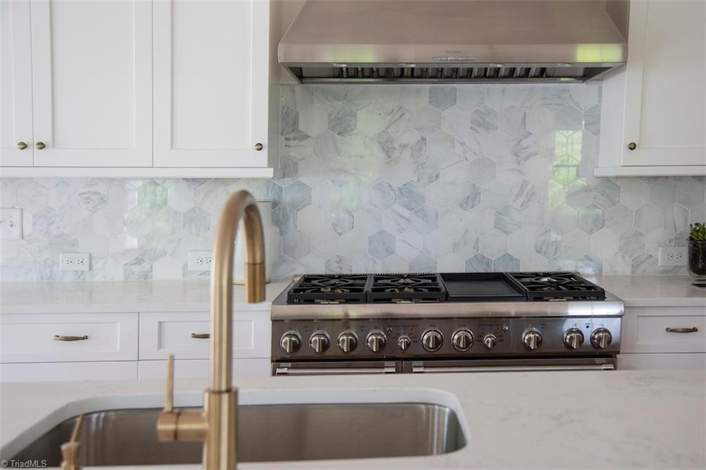 6900 Matzinger Court Oak Ridge, NC 27310 - Photo 11 of 30 Kitchen-Trinsic pull-down kitchen faucet in Champagne Bronze and Thermador 48" dual fuel Pro Harmony range w/griddle.
