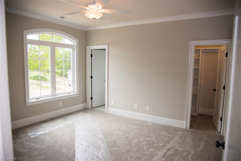 6900 Matzinger Court Oak Ridge, NC 27310 - Photo 22 of 30 Second floor bedroom w/en-suite and closet w/built-ins.