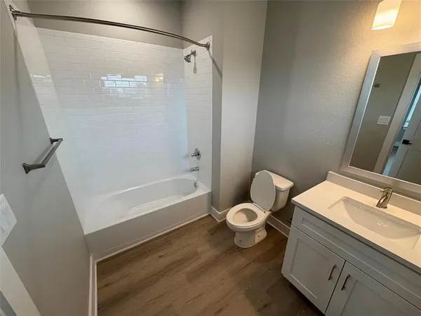 an empty room with wooden floor and white walls