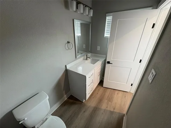a bathroom with a sink toilet and mirror