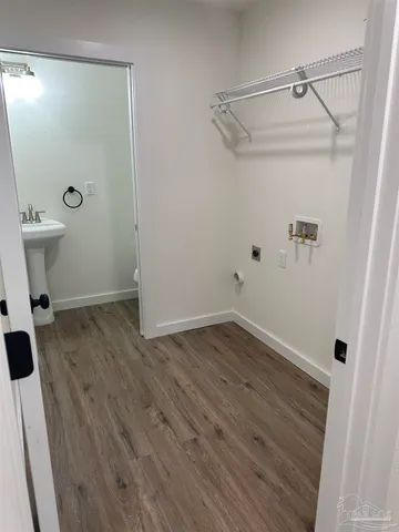 a view of a room with wooden floor and mirror