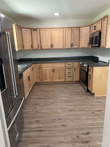 a kitchen with granite countertop a stove and cabinets