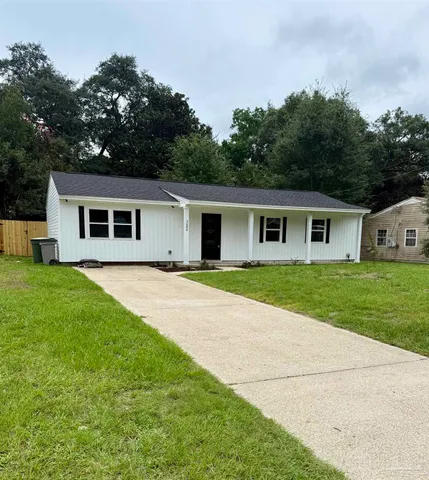 a view of house with a yard