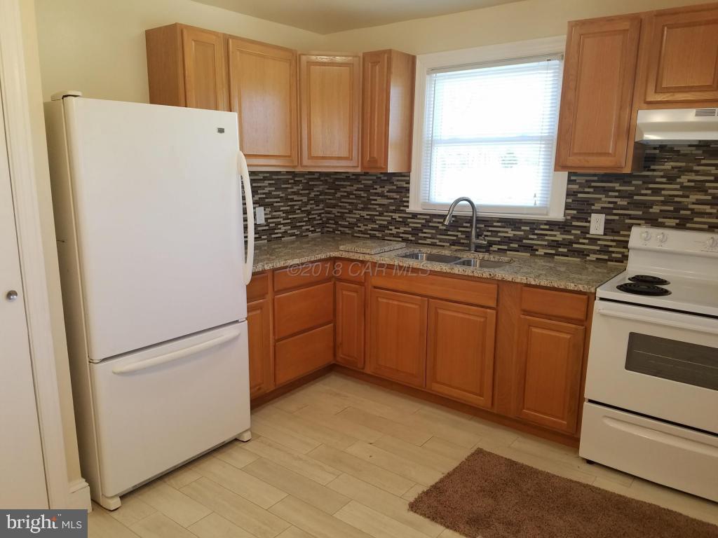 28234 Stanford Road Eden, MD 21822 - Photo 11 of 35 a kitchen with a refrigerator sink and cabinets
