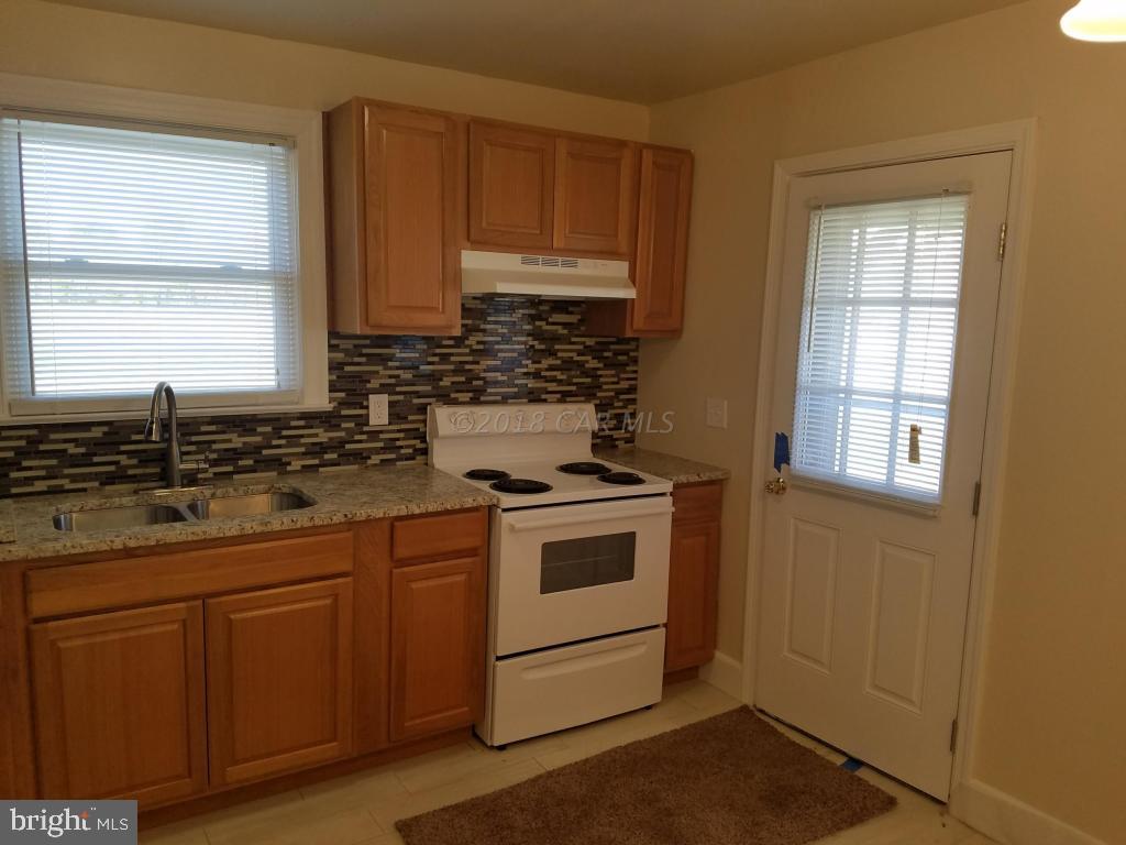 28234 Stanford Road Eden, MD 21822 - Photo 14 of 35 a kitchen with granite countertop white cabinets and white appliances