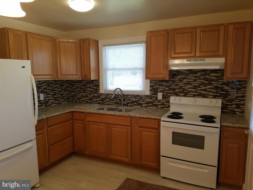 28234 Stanford Road Eden, MD 21822 - Photo 15 of 35 a kitchen with a stove sink and cabinets