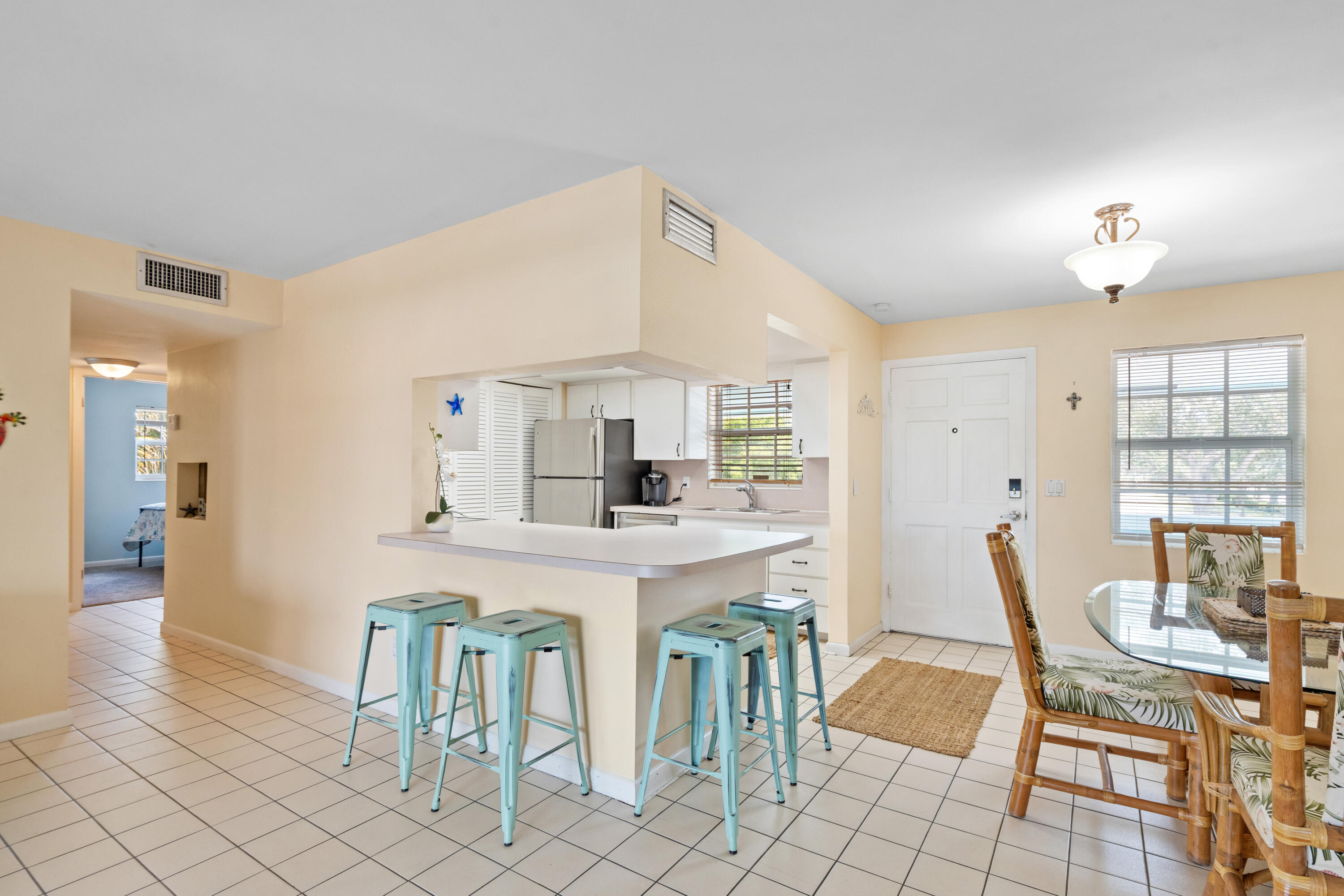 249 Center Street, Unit 2C Jupiter, FL 33458 - Photo 8 of 29 a dining room with furniture and window