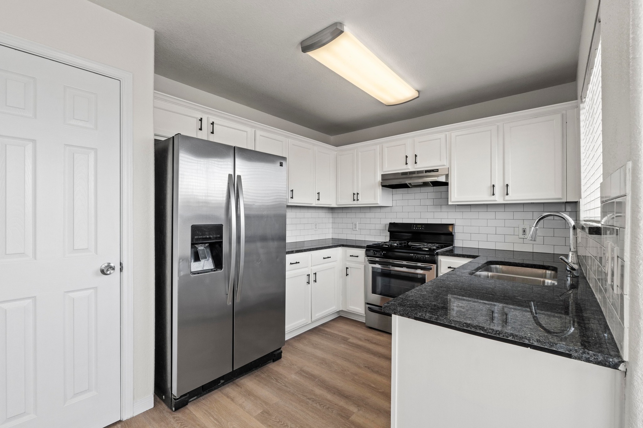 902 Terra Street Round Rock, TX 78665 - Photo 14 of 35 a kitchen with stainless steel appliances granite countertop a refrigerator a stove a sink and a microwave