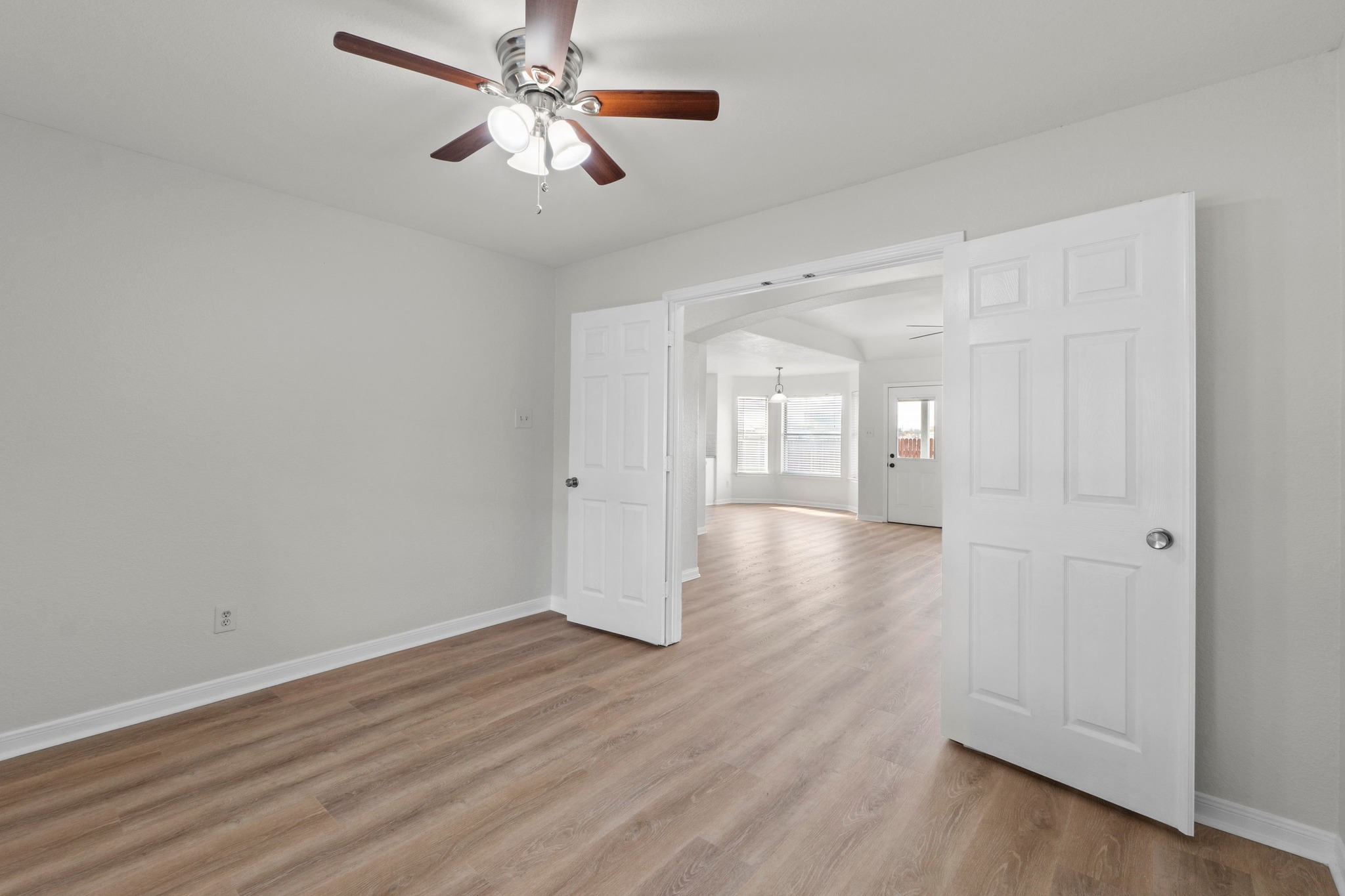 902 Terra Street Round Rock, TX 78665 - Photo 19 of 35 a view of a room with wooden floor and a ceiling fan
