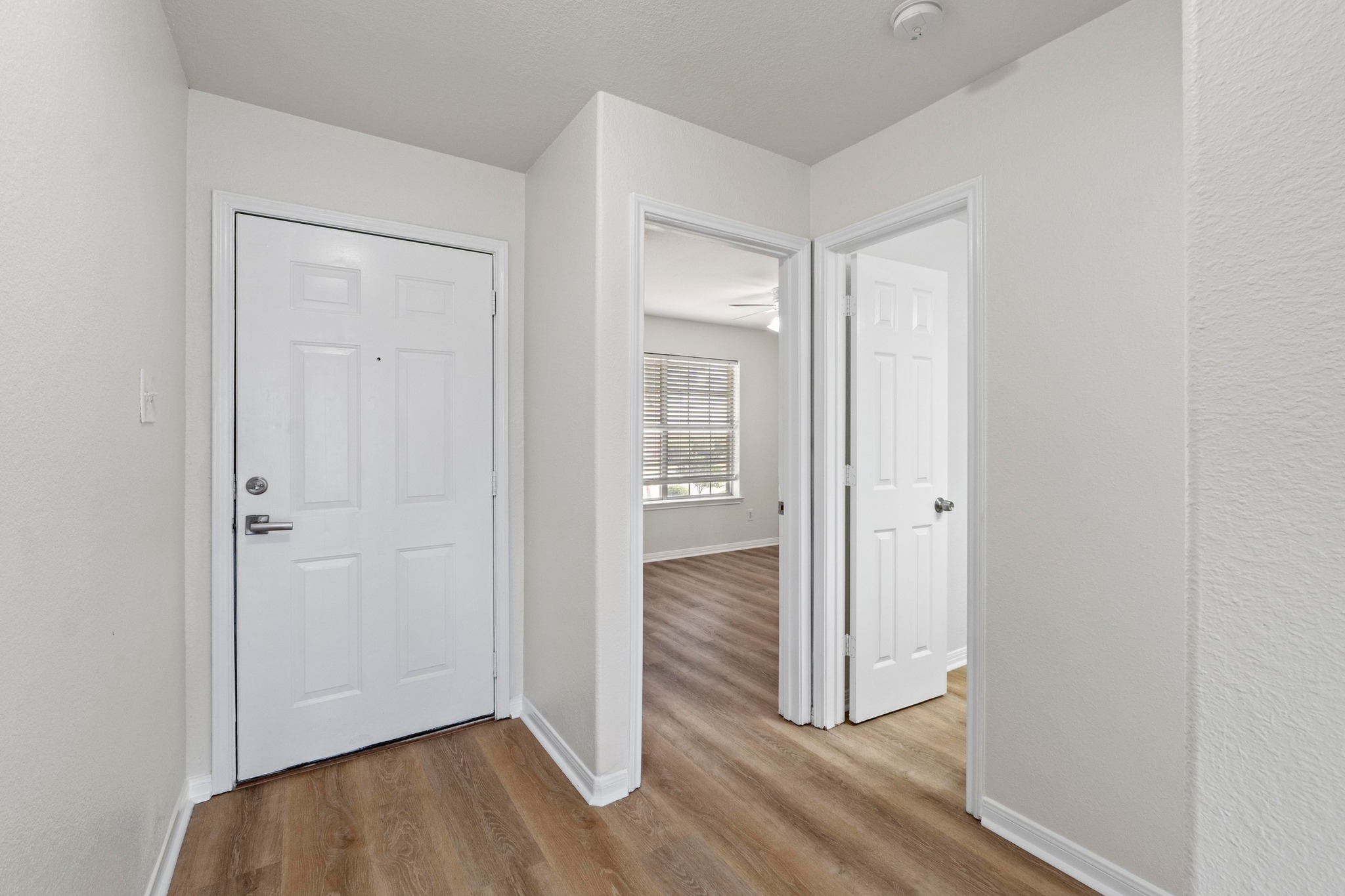 902 Terra Street Round Rock, TX 78665 - Photo 24 of 35 an empty room with wooden floor bathroom and front door