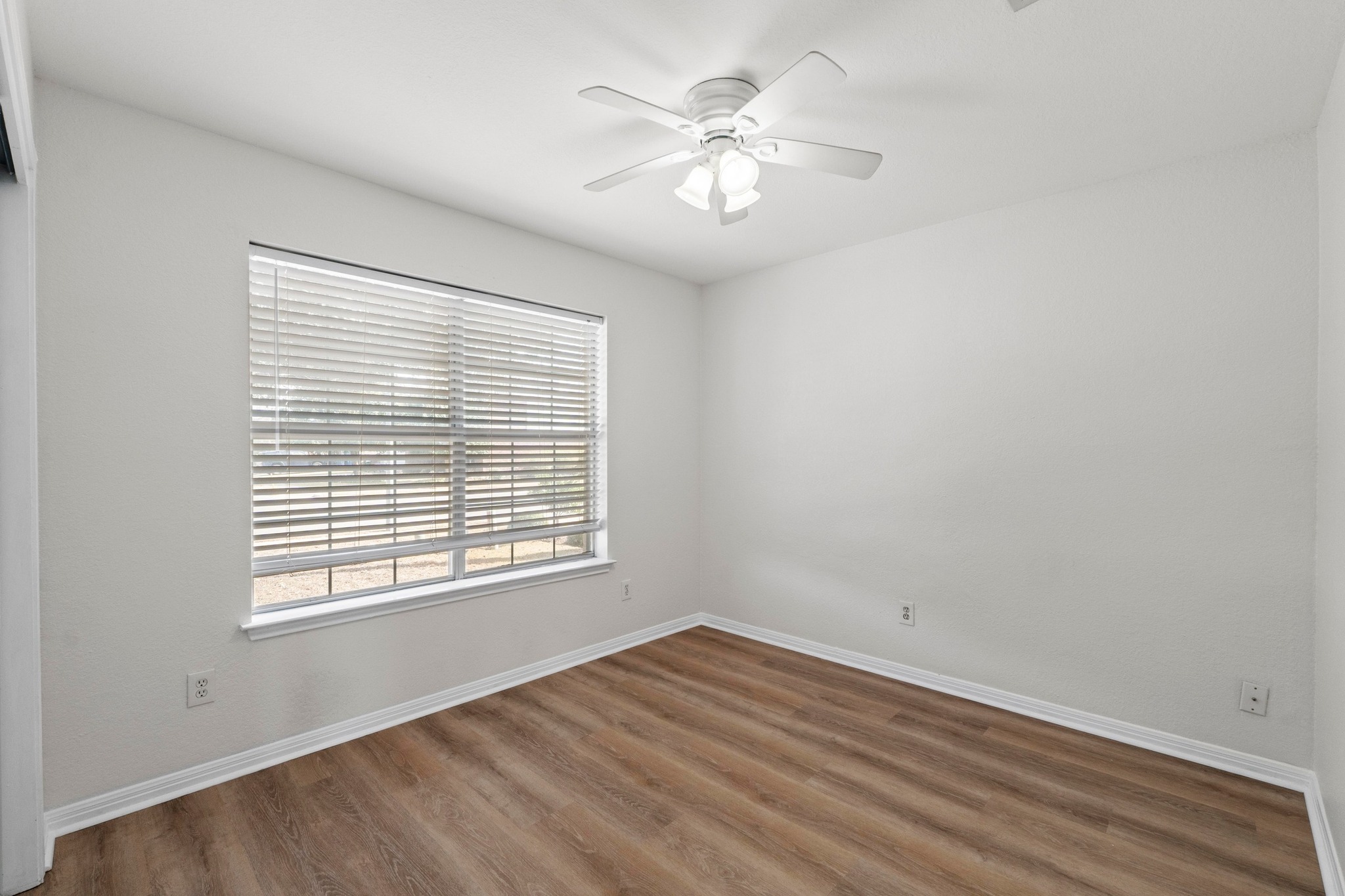 902 Terra Street Round Rock, TX 78665 - Photo 25 of 35 a view of an empty room with a window and wooden floor